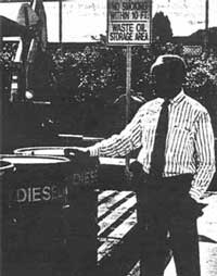 Public Works Director Jordan Rich and oil barrels